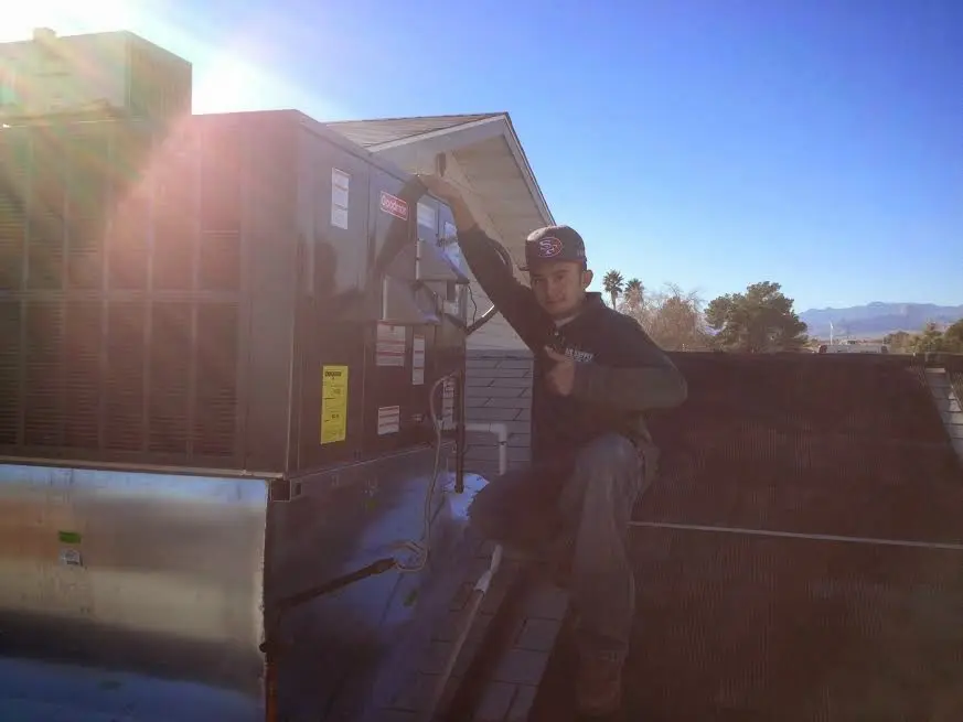 HVAC technician performing HVAC Inspection on a rooftop unit in Clover Creek